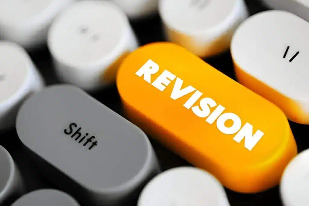 Keyboard keys with the word "Revision" in orange